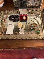 All jewelry pieces arranged on mirrored tray