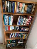 Bookshelves filled with various books on economics, travel, household, and science topics.
