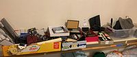 Wide view of the men's accessories laid out on the table showing scarves, wallets, ties, boxes and other items in the lot.