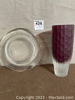 Photo showing top view of frosted glass server and upright two-tone thick burgundy and clear glass vase.