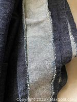 Close-up showing denim fabric texture, color, and edge detailing.