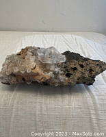 Side view of the apophyllite and heulandite mineral specimen showing crystal cluster on rough matrix.