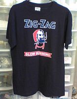 Full front view of navy blue Zig-Zag pirate t-shirt showing logo and SLOW BURNING text