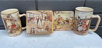 Image showing all four items in the lot arranged in a row with visible Dickens illustrations on mugs, dish, and tray