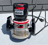 Photograph of vintage Sears Craftsman router showing front view with two handles, red and white calibration ring, and visible Sears Craftsman logo.