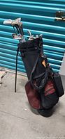 Golf clubs in the black and brown soft carry bag with shoulder strap, showing general condition and overall look of the set