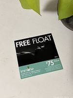 Front view of the free float voucher card showing the value and spa logo.
