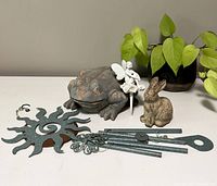 Set showing all four outdoor ornaments - sun-shaped wind chime, large frog, bunny figurine, and white fairy spike