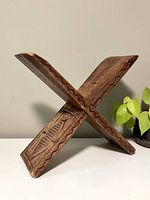 Front angle showing the bookstand set up in an X shape highlighting the carving and wood grain