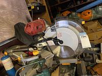 Full view of Chicago Electric miter saw including blade, guard, and motor housing in garage environment