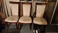 Three chairs grouped: two armless side chairs and one captain’s chair
