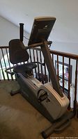 Photo of the left side of the recumbent exercise bike showing seat, backrest and base frame
