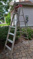 Side view of light aluminum step ladder showing overall height and number of steps