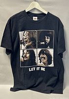 Front view of black Beatles Let It Be T-shirt with images of band members and text.