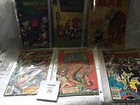 Seven vintage comic books including Huey Dewey and Louie, Woody Woodpecker, Max, Marvel Feature Red Sonja and Conan the Barbarian, DC Comics Beowulf, and Avengers series.
