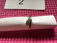 Front view of 14K gold women's wedding ring with twisted bypass design and five small round diamonds set across the top