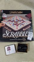 Photo of Deluxe Edition Scrabble Crossword Game box with rotating gameboard and vintage Sawyers View-Master original box with reels.