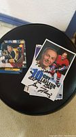 Photo showing a stack of signed hockey cards including one featuring Guy Lafleur.