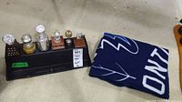 Photo showing six plastic NHL trophies arranged on a black plastic base with a blue Toronto Maple Leaf fleece blanket folded beside it.