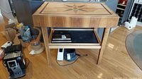 Full view of butcher block island table showing top, legs, lower shelf