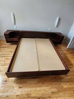 Full view of bed frame with attached headboard and nightstands