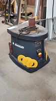 Front-left angle view of Mastercraft sander showing logo, sanding drum on table and power cord