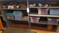Shelves with 5 large totes and various crafting boxes filled with sewing and crafting items
