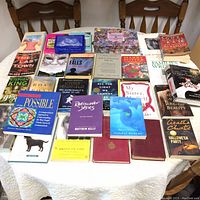 Full view of the book collection on a table showing various titles and genres, including fiction and non-fiction books.
