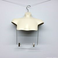 Front view of a white torso mannequin hanger with metal rod and clips for hanging pants or skirts.