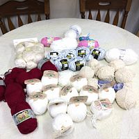 Full yarn collection spread on table showing all yarn varieties and colors