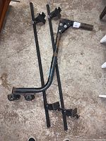 Photo of Thule roof rack crossbars with visible rust on mounting brackets.