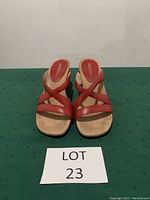 Front view of the red Aerosoles sandals showing the criss-cross straps and beige insole with branding.