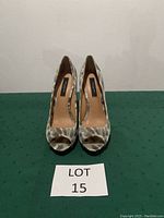 Front view of Ann Taylor patterned open toe pumps with size 7 label and lot number.