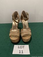 Front view of Bakers cream platform wedge sandals, size 7.5, showing the toe straps, platform soles, and ankle straps.