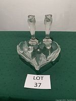 Photo of heart shaped crystal bowl with embedded floral pattern and 2 matching crystal candlesticks.