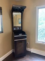 Front view showing full height bar unit with mirror back, drawer, and lower cabinet door.