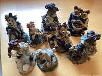 Photo showing the full set of 8 Boyd's Bears collectible resin figurines arranged on a surface.