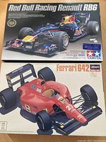 Both kit boxes side by side showing artwork for Ferrari 642 and Red Bull Racing Renault RB6