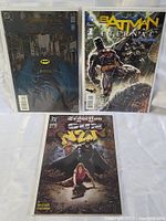 Three Batman-themed DC comic books individually bagged and displayed against a white background.