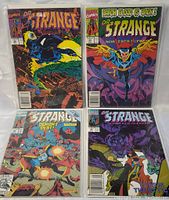Full view of 4 Doctor Strange comic books, each in a protective sleeve, showing colorful Marvel covers with Doctor Strange characters and themes