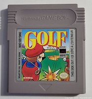 Front of gray Nintendo Game Boy cartridge showing colorful label for Golf game with golfer illustration and text.