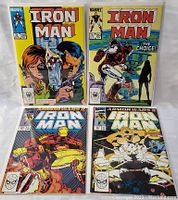 Front view of four Iron Man vintage comic books showing issues #203, #204, Armor Wars I and II
