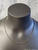 Overall view of the sterling silver box chain necklace displayed on a mannequin bust.