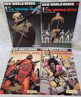 Four The Walking Dead comic books, New World Order series, laid out to show all covers.