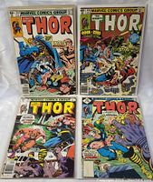 Lot of 4 vintage Marvel Thor comic books arranged in two rows, each featuring full-color action covers with characters and story titles visible.