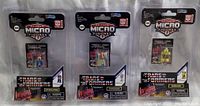 Three Transformers Action Micro Figures in original sealed packages. Left to Right: Grimlock, Optimus Prime, Bumblebee.
