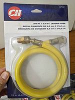 Packaged new Campbell Hausfeld 3/8 in. x 2.5 ft. leader hose whip, yellow color with brass fittings visible