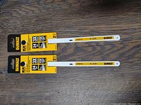 Four Dewalt branded 10-inch hacksaw blades displayed, showing packaging with details like 24 TPI and Bi-Metal material.