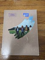 Front cover of the sheet music book showing band photo and stickers about color photos.