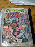 Front cover of All-Out War comic book showing Viking Commando artwork and various battle scenes, inside a clear plastic sleeve.